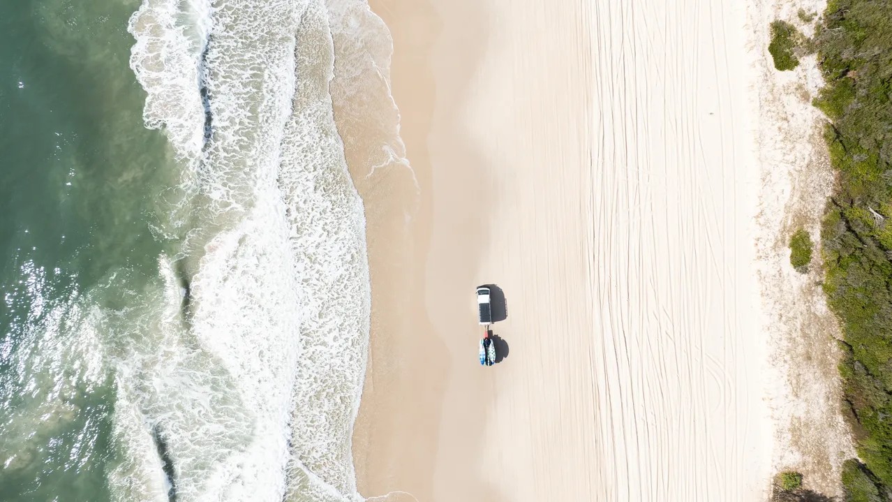 Car driving along the beach